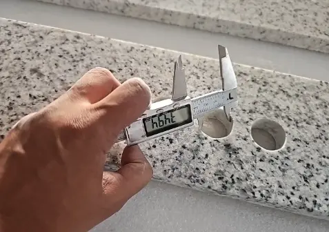 Checking faucet hole position