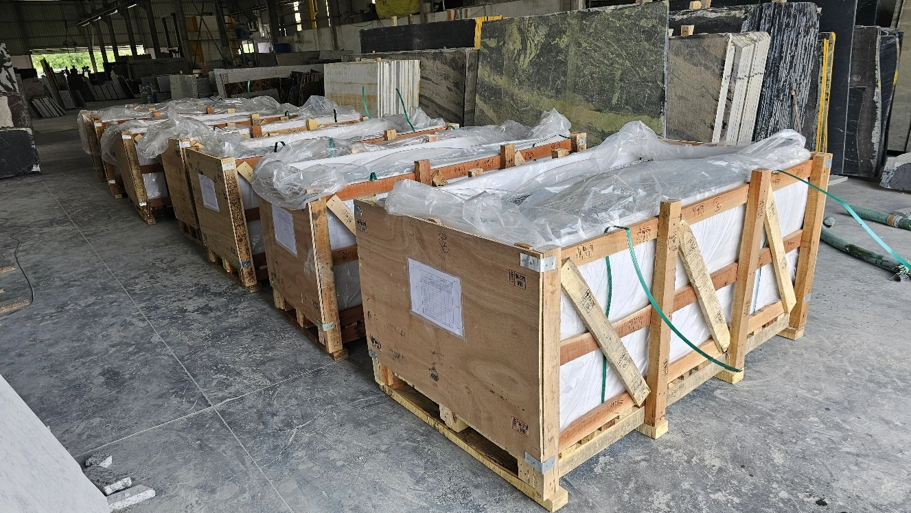 Lined-up wooden crates containing finished stone countertops