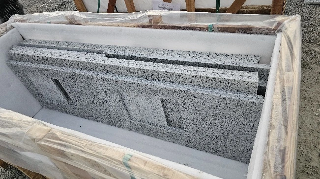 Inside view of a crate showing stacked countertop pieces